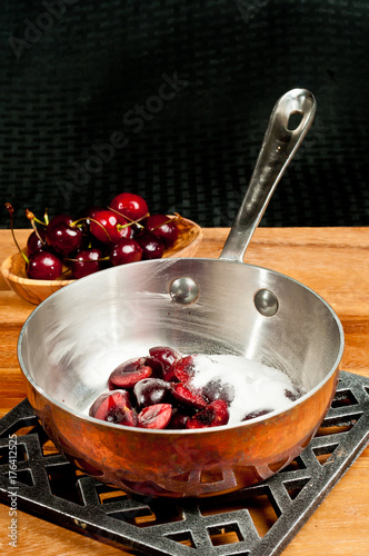 Fotografie, Obraz Sauce pan of cherries / preparing to heat sauce pan of halved, pitted and washed