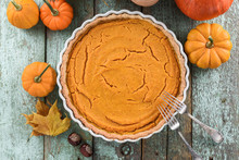Traditional Homemade Open Pumokin Pie Decorated With Bright Orange Pumpkins And Marple Leaves On Blue Wooden Background