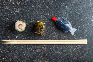 Wall Mural - Japanese sushi rolls, chopsticks and fish sauce.