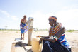 © Hugh Sitton/Stocksy - Samburu women collecting water from well in desert.  Kenya.