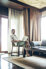Man Working on a Laptop Computer at Home