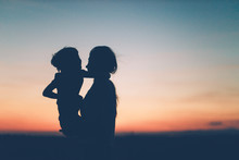 Mother And Daughter Enjoying The Sunset