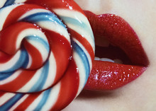Red Shiny Lips And Spiral Candy Closeup