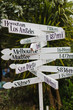 © Leandro Crespi/Stocksy - Travel destinations on crossroad sign