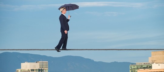 Poster - Composite image of businessman with umbrella walking on white
