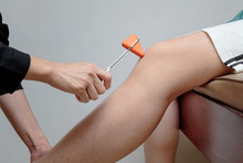 Doctor Doing Examining Knee Reflex Test On Patient's Knee,neurology Test