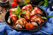 © timolina - Eggplant (aubergine) rolls with meat in tomato sauce. Flat lay. Top view