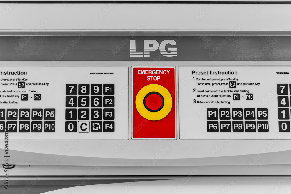 closeup emergency stop red button at control panel LPG gas fuel pump machine