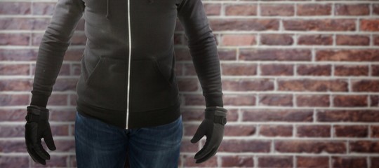 Wall Mural - Composite image of robber wearing black hoodie