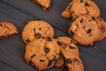 Cookies with chocolate on dark wooden background