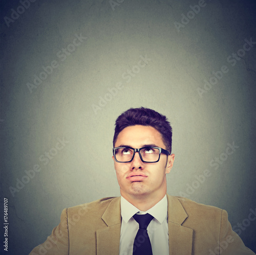 Fotografie, Obraz Bored annoyed young business man looking up