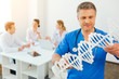 © zinkevych - Mature male doctor examining DNA model at work
