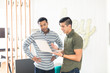 © Connect Images - Cool young businessmen in creative office looking at laptop