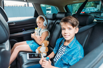 brother and sister ready for car trip