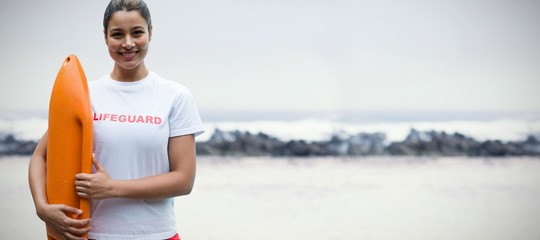 Composite image of portrait of female lifeguard holding rescue