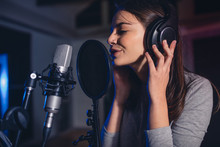 Female Vocal Artist Singing In A Recording Studio
