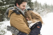 © Westend61 - Happy young couple having fun in snow-covered winter forest