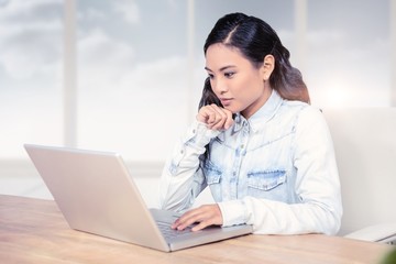 Poster - Composite image of asian woman using laptop