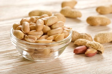 Wall Mural - salted peanuts on wooden background