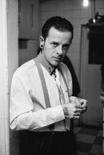 Black And White Portrait Of A Man Dressed As A Gangster At A House Party.