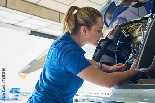 Fotografie, Obraz Female Aero Engineer Working On Helicopter In Hangar