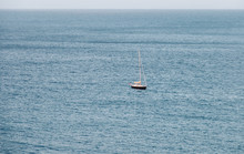 Sailboat On On Calm Blue Ocean