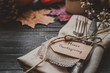 Thanksgiving decoration with cutlery and napkin on the wooden table, close up