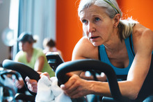 Older Caucasian Woman Working Hard During Spin Cycle Class