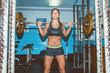 © dijanato/Stocksy - Woman in the gym doing squats with barbell