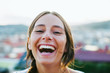 © BONNINSTUDIO/Stocksy - Portrait of a young woman laughing outside.