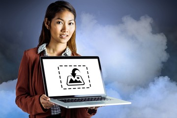 Sticker - Composite image of smiling businesswoman showing a laptop