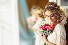 Portrait Of A Beautiful Bride With A Wedding Bouquet. Blonde Girl With Curly Hair And Fashion Makeup.