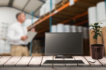 Poster - Composite image of a computer over a desk 