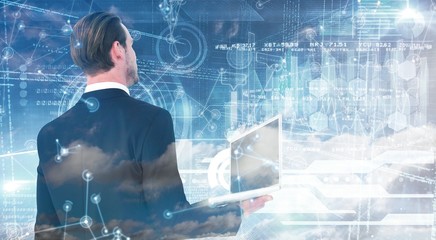 Poster - composite image of businessman looking up holding laptop
