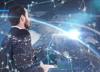 Poster - composite image of businessman in suit holding laptop