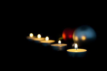 Christmas candle decoration isolated on black.