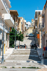 Wall Mural - Street with steps in Sitia town, Crete island, Greece