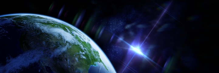 Wall Mural - sun appears over the horizon of planet earth
