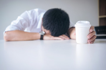 Poster - Tired businessman sleeping at work in modern office with hand holding coffee cup, people dozing on workplace