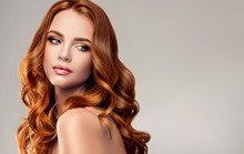 Beautiful Model Girl With Long Red Curly Hair .Red Head . Care And Beauty Hair Products  