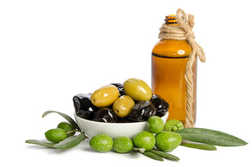 Wall Mural - Black and green  olives  mixed in the  porcelain bowl and Virgin olive oil in a crystal bottle isolated on white background