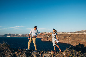 Wall Mural - happy couple goes holding hands, the girl follows the guy