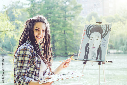 Young Artist Girl Painting A Self Portrait In A Park Near