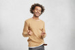 © wayhome.studio  - Stylish happy African American male wears casual clothes, points in camera with fore fingers, chooses someone, has joyfull expression, rejoice success and good luck during day. Ethnicity and happiness