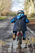 Boy cycling through muddy puddle