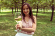© allenkayaa - Young woman with white wine in the park