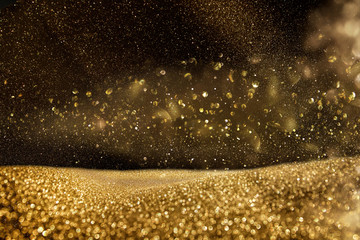 glitter vintage lights background. gold and black. de focused