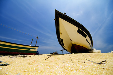 Wall Mural - Beautiful scenery, traditional fisherman boat moored over beautiful sea view and sandy beach under bright sunny day