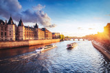 Fototapeta Paryż - Dramatic sunset over Cite in Paris, France, with Conciergerie, Pont Neuf and river Seine. Colourful travel background. Romantic cityscape.