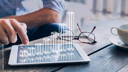 Fotografía Businessman analyzing growing 3D AR chart above tablet computer screen
